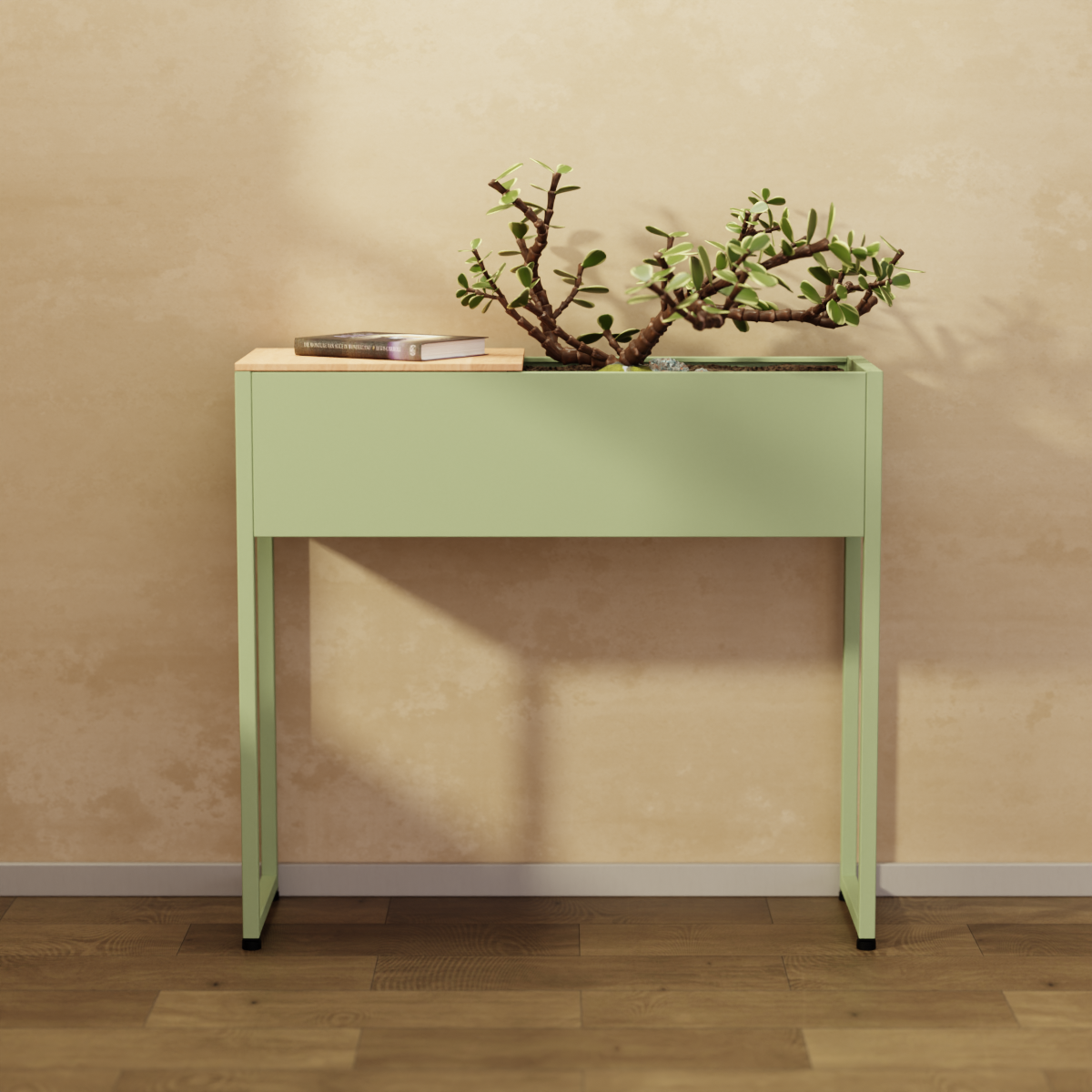 INOX Living Edelstahl Plantbox "Stockholm" in blassgrün, mit Pflanze bestückt und Buch auf dem Ablagebrett vor einer beigen Wand