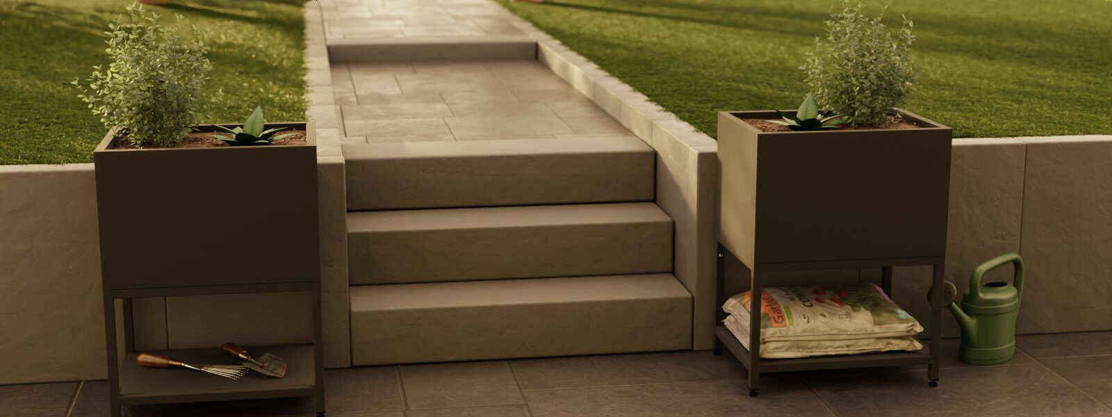 Zwei Edelstahl Planboxen "Madeira" in schwarz, bepflanzt, rechts uns links neben einer Betontreppe und vor Wiese im Garten